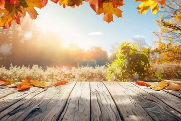 Naklejka na ściany i meble Wooden table with autumn leaves in sunny day background