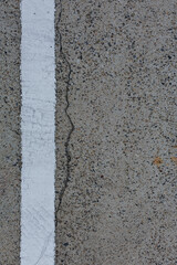 Weather Cracked Cream White Coarse Parking Lot Pavement Background with White Stripe