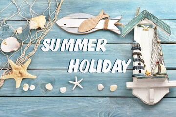 blue wooden background with summer souvenirs and inscription