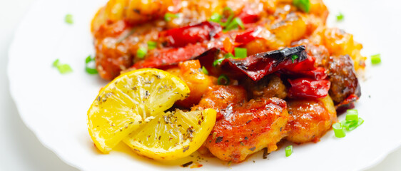 A plate of food with a lot of red peppers and onions