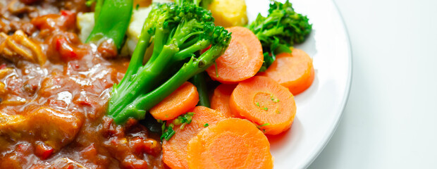 A plate of food with meat, french fries, and vegetables