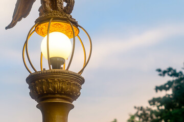 The yellow light of the street lamp has a beautiful blue sky background.
