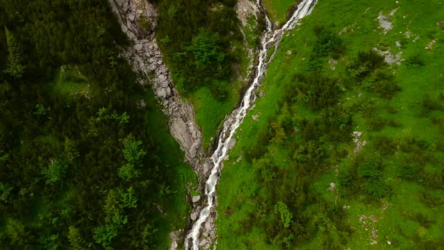 Wasserfall am Nebelhorn Luftaufnahme. Waterfalls in gorge near Mount Nebelhorn in Bavaria, Germany in summer aerial view. Waterfall in rock gorge of Alps. Valley with waterfall near Obersdorf. 