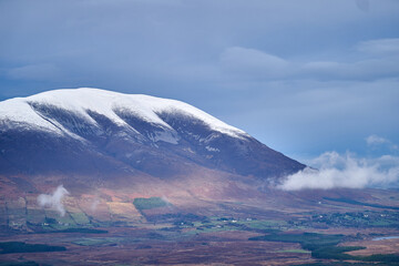 Snow on Nephin mountain dramatic sky low clouds Ireland