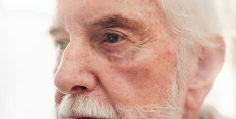 Dementia, eyes or nostalgia with senior man in retirement home for idea, memory or thinking. Anxiety, eyesight and mental health with elderly person in living room of apartment for planning or vision