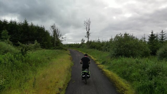 Aerial view of a cyclist in the woods on an e-bike