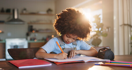 Boy, home and writing homework on table in house, education and school work with kid or notebook....