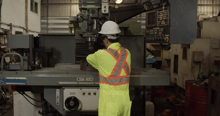 Worker prepare old machine tool in factory.