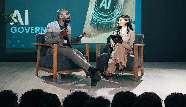 Event, presentation and people with mic at stage for innovation, speech or future development. IT, seminar and woman with man in conversation for ai governance, machine learning or ethical guidelines