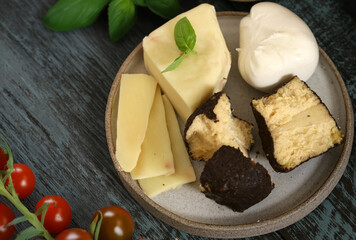 assorted cheeses for snacks on a board