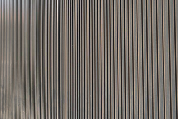 Wall metal sheet texture background for modern design. Silver aluminum shiny for roof warehouse. Texture of corrugated sheet metal facade. Panorama of black metal texture surface galvanized steel