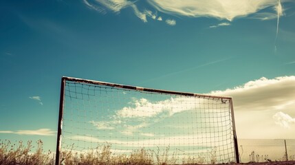 Fototapeta premium Empty Soccer Goal Against Blue Sky With Clouds