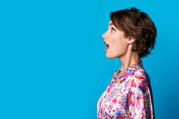 Profile portrait of impressed speechless person open mouth look empty space isolated on blue color background © deagreez