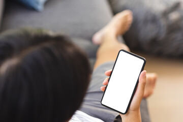 A young Asian male college student holding smartphone with blank screen
