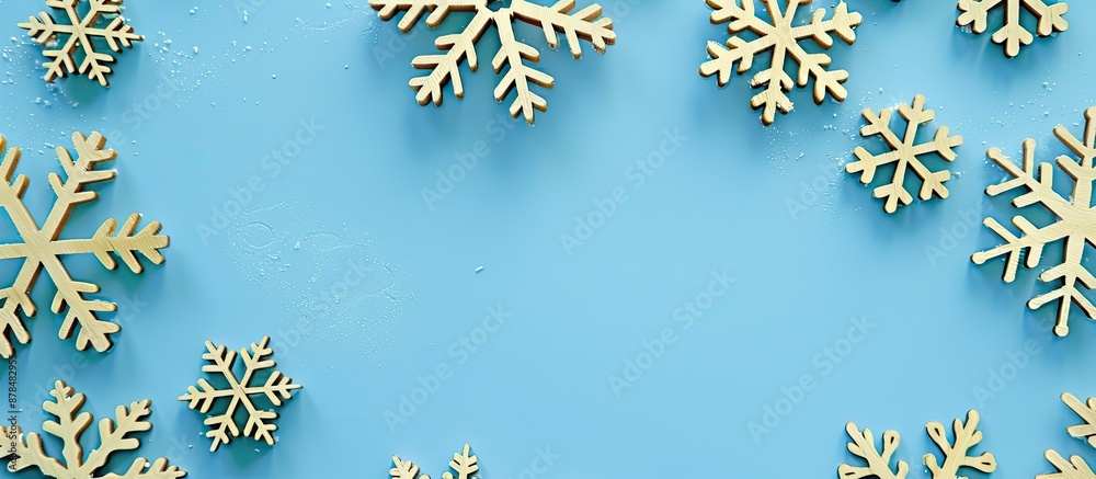 Poster close-up view of decorative wooden christmas snowflakes on a blue background, creating a festive new