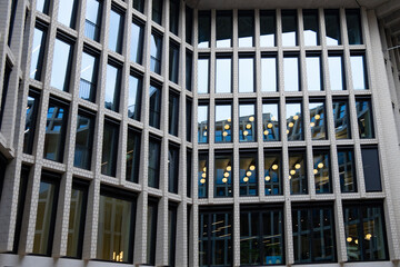 Fototapeta premium fragments multi-storey office and residential buildings in European city with reflective glass facades, modern high-rise office buildings and residential towers