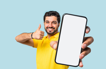 Indian asian Bearded Man Holding Smartphone Empty Screen, 3D Effect Hand Close-Up, Blue Background