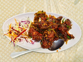 Delicious chicken lollipops with salads 