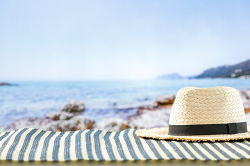 Beach accessories on summer beach mat on a tropical sandy beach. Seascape background. Copy space...