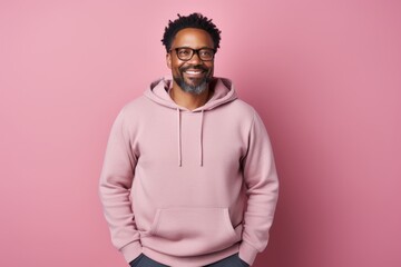 Obraz premium Portrait of a satisfied afro-american man in his 40s wearing a zip-up fleece hoodie in front of pastel or soft colors background