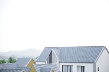 Modern design of residential house urban style with front porch cover and bay windows against clear sky. Modern single family terraced homes. Newly built homes in a residential estate in 2025.