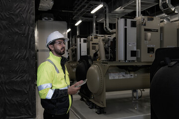 workers in factory. engineer work in Industrial chiller HVAC heating ventilation air conditioning system and pipping line of industrial construction at boiler pump room system in the factory.