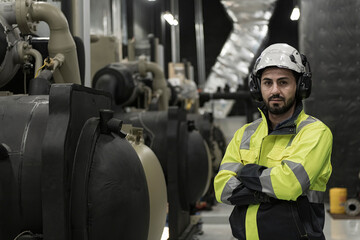 workers in factory. engineer work in Industrial chiller HVAC heating ventilation air conditioning system and pipping line of industrial construction at boiler pump room system in the factory.