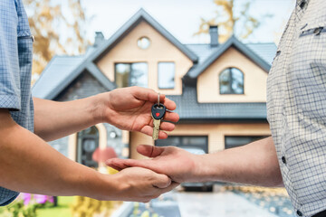 The realtor hands over the keys to the new building to its future owner.