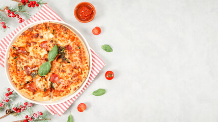 Round baked pizza in a plate with a red striped kitchen napkin