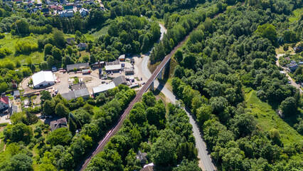 Drone photography of road, traffic, forest and houses during summer day