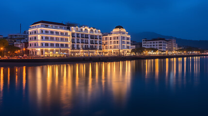 Fototapeta premium Romantic cityscape with warm lights reflecting on calm water, blue and yellow, perfect for travel and vacation. 
