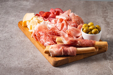 Charcuterie board. Antipasti appetizers of meat platter with salami, prosciutto crudo or jamon and olives.