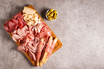 Charcuterie board. Antipasti appetizers of meat platter with salami, prosciutto crudo or jamon and olives.