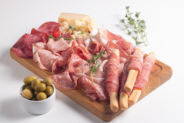 Charcuterie board. Antipasti appetizers of meat platter with salami, prosciutto crudo or jamon and olives.