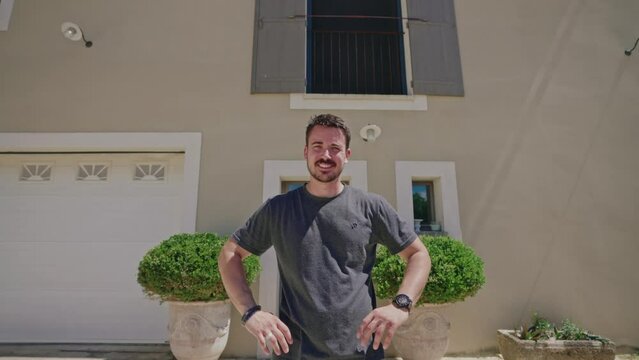 Happy Man Standing Outside House