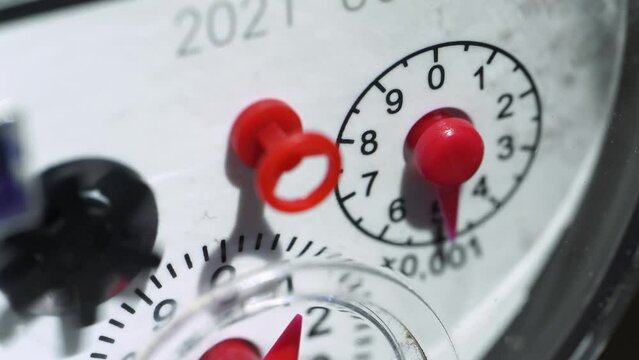 Water meter shows household consumption of water, close up. Water meter in box with pipes built into the wall . Water consumption measuring device.	
