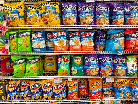 Variety of chips from Frito-Lay at a grocery store aisle at supermarket