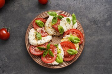 Caprese Salad with tomato, mozzarella, basil, olive oil, sweet balsamico and black pepper