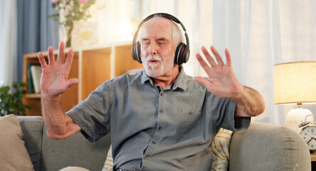 Old man, headphones and dancing in home, music and having fun in retirement or streaming sound. Elderly male person, playlist and living room hip hop for audio therapy, freedom and listening on sofa © WesSide/peopleimages.com