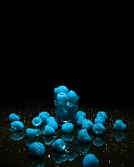 Shot Glass Overflowing with Blue Raspberries