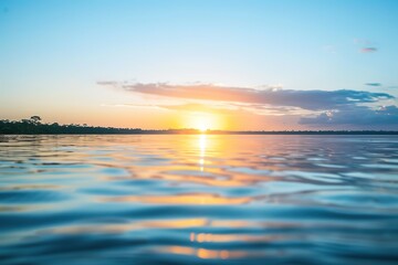 Fototapeta premium Sunrise over calm lake, warm colors, reflective water.