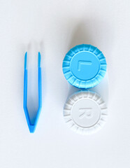 Contact lenses with a container, tweezers, glasses in case. Ccorrecting myopia. Contact lens care, cleaning, health. White Background