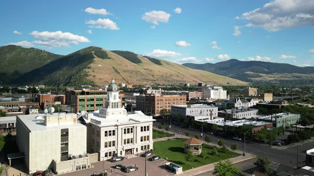 Missoula Montana aerial of downtown buildings with mountain backdrop in summer