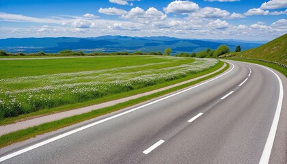 Rural Spring Landscape featuring a picturesque road surrounded by green fields, mountains, blue sky with fluffy clouds, and a vibrant horizon on a sunny day