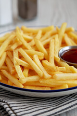 Homemade American French Fries with Ketchup on a Plate, low angle view. Close-up.