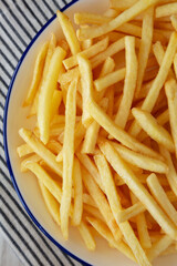 Homemade American French Fries on a Plate, top view. Close-up.
