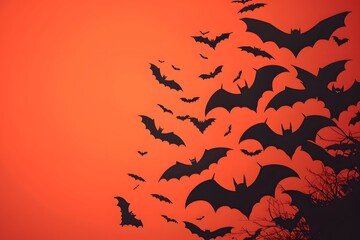 Obraz premium Silhouettes of bats flying against a vibrant orange sky, perfect for Halloween themes.