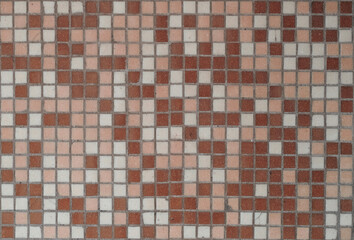 Background is a mosaic with texture of ceramic tile walls.
