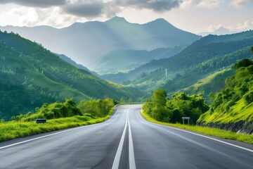 Fototapeta premium A road with a mountain in the background. The road is empty and the sky is cloudy