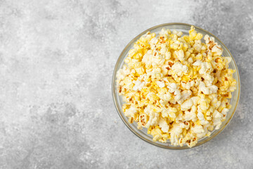 Bowl of salted popcorn on texture background.Cinema and entertainment concept. Movie night with popcorn. Delicious appetizer, snack. Place for text. Copy space. Banner